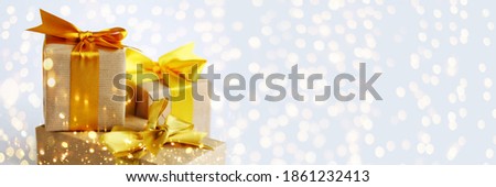 Light illuminating banner with tree gift boxes wrapped by kraft brown paper and yellow satin bows. Universal gifts design for all kind of celebration 