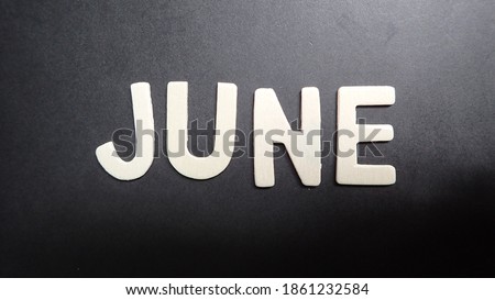 June month letterpress wood on black background