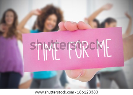 Woman holding pink card saying time for me against class in gym Royalty-Free Stock Photo #186123380