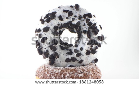 Close-up, detailed. donut with white icing and chocolate chips. White background.