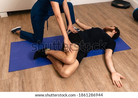Stock photo of relax man receiving massage by physiotherapist professional.