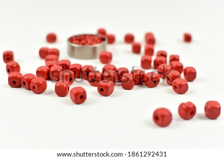 Small wooden beads and metal rings.