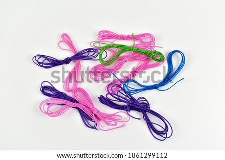 Colorful stringing cords on a light background.
