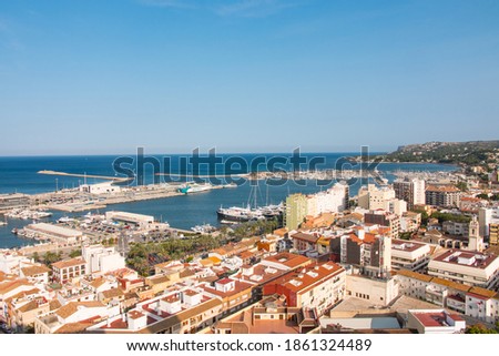 Denia cityscape, harbor (port) and seascape. Aerial view from the historic moorish castle mirador. Costa Blanca, Valencian community, Spain.  Royalty-Free Stock Photo #1861324489