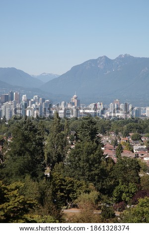 View of Vancouver downtown skyline with mountains and ocean during summer seen from Queen Elizabeth Park in Vancouver,  British Columbia, Canada