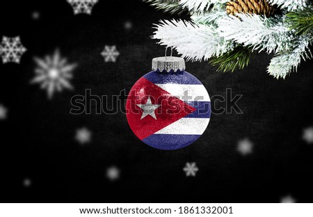 Happy new Year 2021, flag of Cuba on a christmas toy, decorations isolated on dark background. Creative christmas concept.