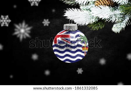 Happy new Year 2021, flag of British Territory in the Indian Ocean on a christmas toy, decorations isolated on dark background. Creative christmas concept.