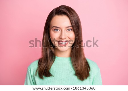 Photo portrait of cheerful happy brunette girl smiling isolated on pastel pink color background