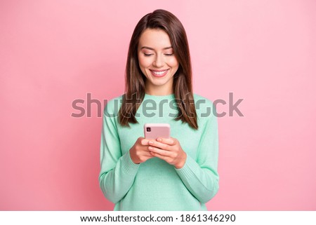 Photo of attractive person looking smartphone communicate teal pullover isolated on pink color background