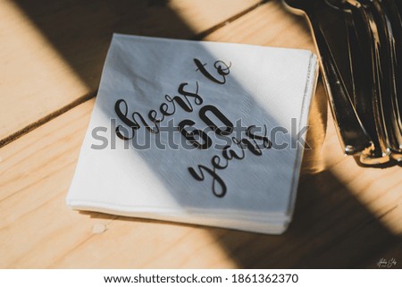 Close up of a decorative napkin of a 60 years anniversary with golden letters