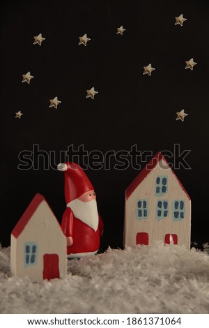 Santa Claus in night city and stars in black sky. Christmas concept. Image contains copy space