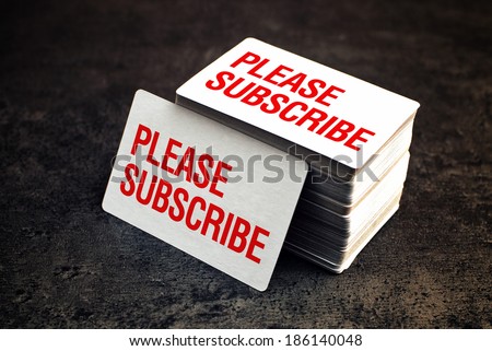 Please subscribe business cards with rounded corners. Stack of blank horizontal business cards propped up another.