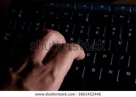 Man's hand on personal computer keyboard, close up view. Digital input concept.