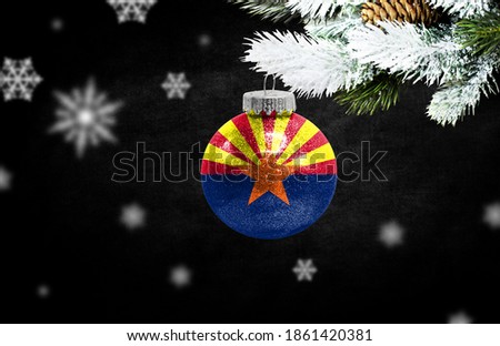 Happy new Year 2021, flag State of Arizona on a christmas toy, decorations isolated on dark background. Creative christmas concept.