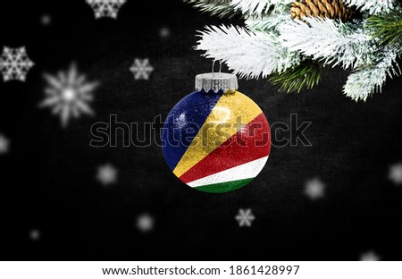 Happy new Year 2021, flag of Seychelles on a christmas toy, decorations isolated on dark background. Creative christmas concept.