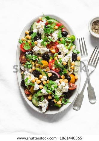 Greek chickpeas salad on light background, top view. Vegetarian healthy diet food