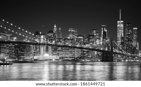 Black and white night view of Manhattan waterfront, New York City, USA.