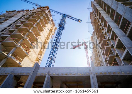Crane construction site working background. Concrete residential skyscrapers buildings in city