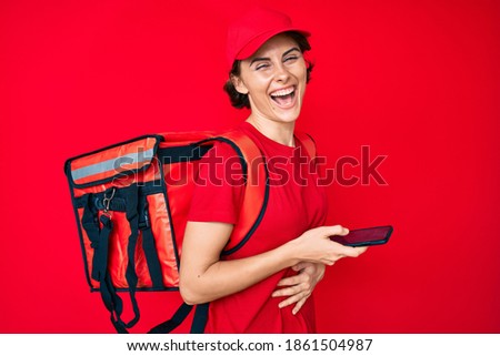 Young hispanic woman holding delivery box calling assistance smiling and laughing hard out loud because funny crazy joke. 