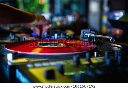 Party dj playing music on stage. Disc jockey plays music set on a hip hop party
