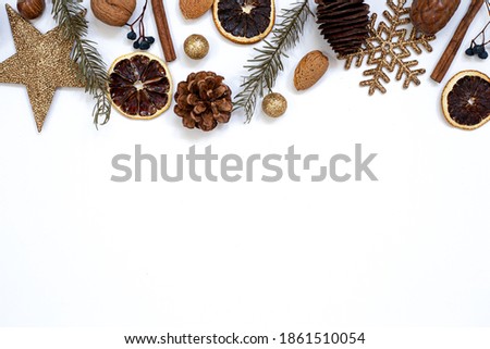 Top view flat lay christmas decoration pine cone orange nuts golden snowflake christmas tree branch glitter balls