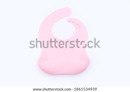 Pink silicone baby bib isolated on white background Royalty-Free Stock Photo #1861534939