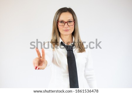 Business woman showing victory sign isolated on white background.