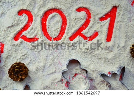 Happy new year 2021. Preparing for Christmas. Christmas background with numbers 2021. Cooking Christmas cookies. Gingerbread Cookie