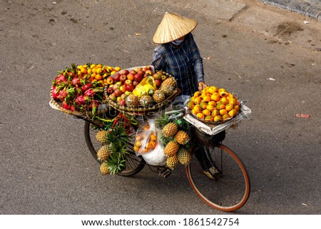 Transport of fruits on a bicycle in the streets of Hanoi in Vietnam 