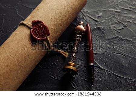 Last will, pen and notary seal on a dark table close-up