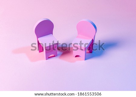Empty Chairs Against Pink Background
