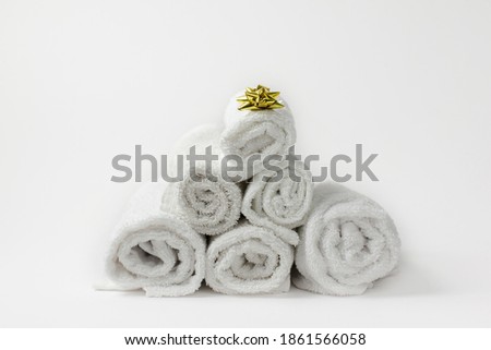 Christmas composition with towels and golden bow. Christmas tree from towels. Christmas, hygiene and skincare concept
