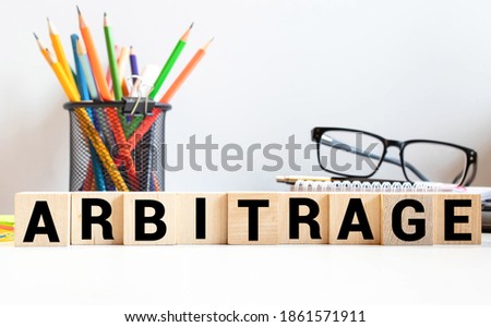ARBITRAGE word made with building blocks. concept Royalty-Free Stock Photo #1861571911