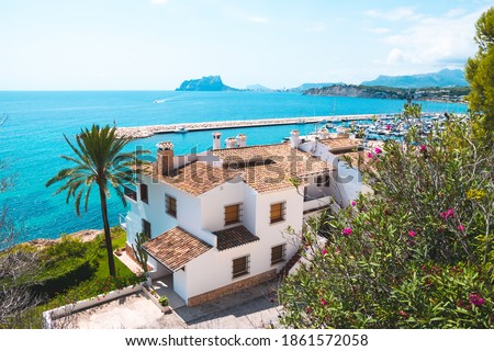 Traditional white houses with unspoiled idyllic view of marina, coastline and Mediterranean Sea in Moraira, Costa Blanca, Spain Royalty-Free Stock Photo #1861572058