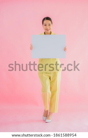 Portrait beautiful young asian business woman smile with empty white billboard card on color background