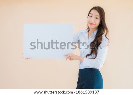 Portrait beautiful young asian business woman show white empty billboard banner on isolated color background