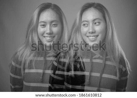 Portrait of happy young Asian woman wearing hoodie