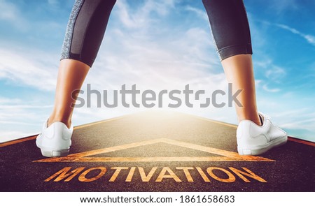 Woman runner leg standing on a motivation road sign leading to a freedom bluesky for motivation concept.