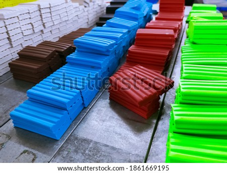 Heap of plasticine at production line in factory. Multi-colored modeling clay. Plasticine manufacturing industry. Modeling clay material for kids art education. Plasticine for preschool playdough.