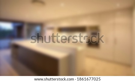 Beautiful blurred luxury estate home kitchen with color cabinets. fit for your design interiors project.