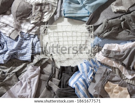 Frame made of clothing as pyjamas, undergarments, garments on a white marble background. Apparel sorting and decluttering. Concept of organic cotton clothing manufacturing. Nordic style. Copy space. Royalty-Free Stock Photo #1861677571
