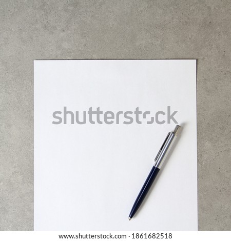 Template of white paper with a ballpoint pen on light grey concrete background. Concept of new idea, business plan and strategy, development and implementation of content. Stock photo with empty space