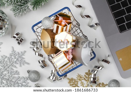 Christmas online shopping. laptop and presents in basket with decorating , prepare to xmas. Winter holidays sales. top view flat lay