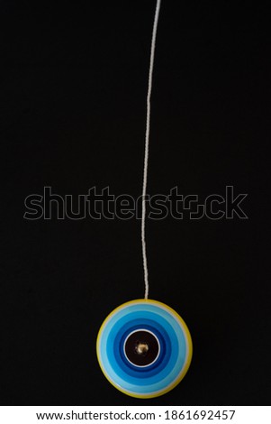 Yo-yo Traditional Mexican wooden handcraft toy, black background