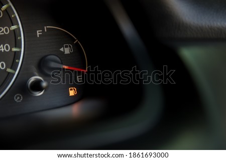 Empty fuel warning light in car dashboard. Fuel pump icon. gasoline gauge dash board in car with digital warning sign of run out of fuel turn on. Low level of fuel show on speedometer dashboard. Royalty-Free Stock Photo #1861693000