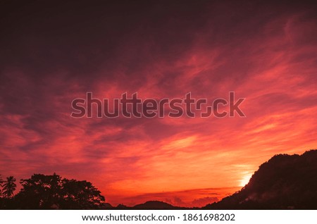 Orange twilight evening with silhouette of mountain