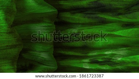 Green cloth. Silk fabric in fine organza with panther print, Crumpled texture. Background. Template.