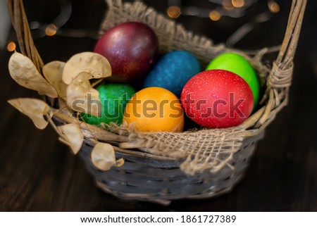 Easter chicken painted eggs in a decorated wicker basket