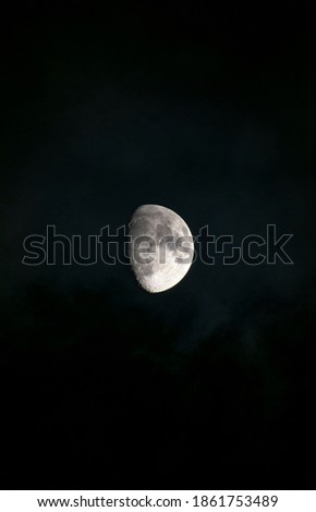Picture of the moon with some cloud cover