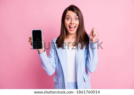 Photo of young girl happy smile shocked surprised hold smartphone win lottery wear jacket isolated over pastel color background